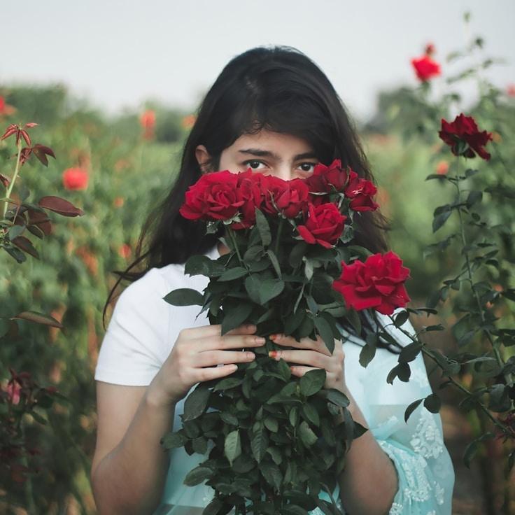 Kaveri Mehta, Lead Design Curator at Crystal Harbor Station, reviewing corporate floral arrangements